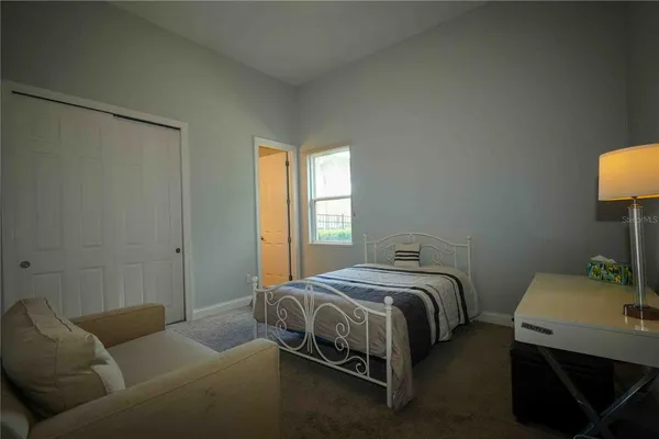 a bedroom with a bed and a couch