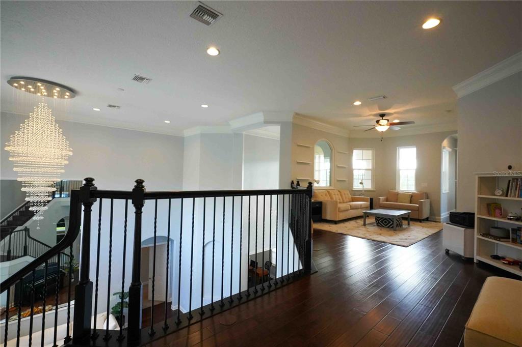 6219 Tiroco Way Windermere, FL 34786 - Photo 20 of 41 a view of a hallway with dining room and wooden floor
