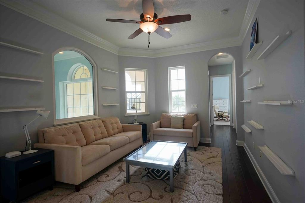 6219 Tiroco Way Windermere, FL 34786 - Photo 21 of 41 a living room with furniture and a large window