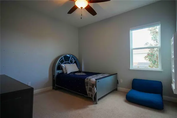 a bedroom with bed and a window