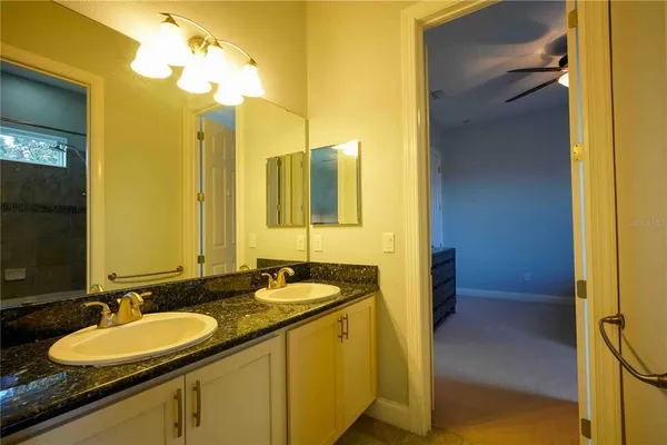 a bathroom with a double vanity sink and a mirror