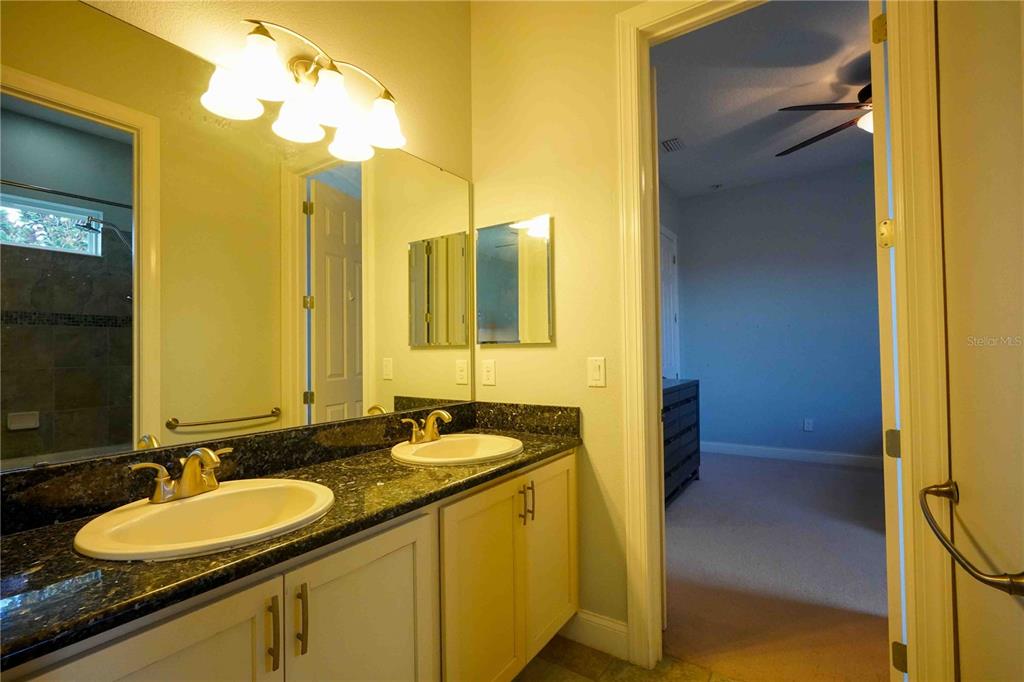 6219 Tiroco Way Windermere, FL 34786 - Photo 27 of 41 a bathroom with a double vanity sink and a mirror