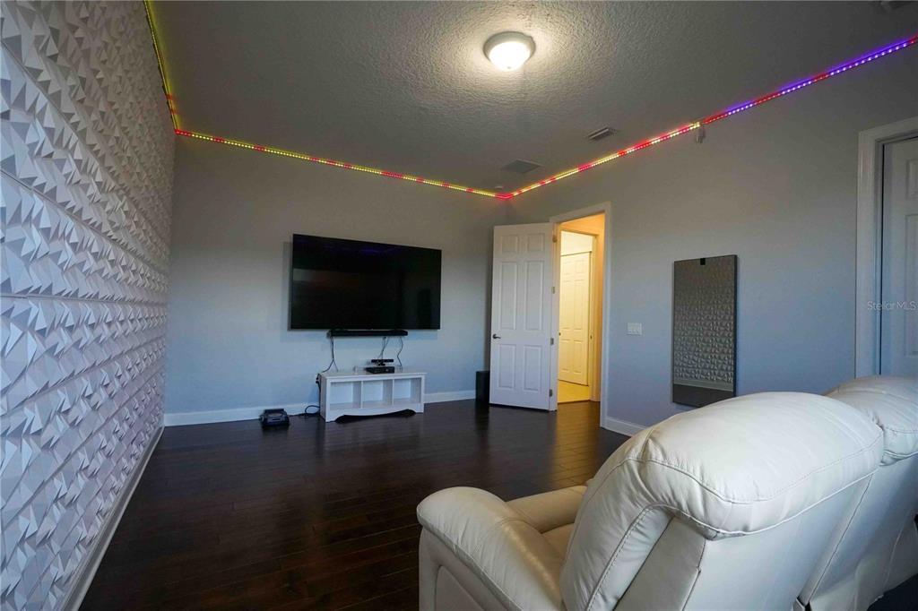 6219 Tiroco Way Windermere, FL 34786 - Photo 29 of 41 a living room with furniture and a flat screen tv