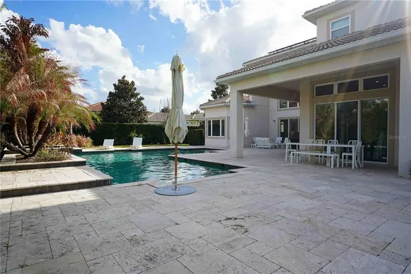 a view of a house with backyard and sitting area