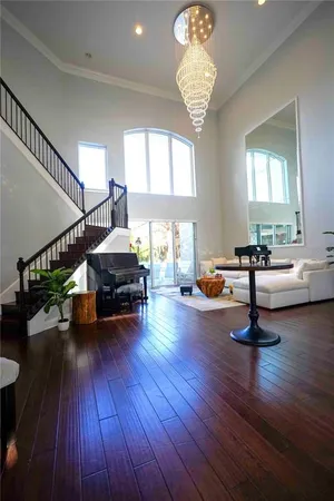 a living room with furniture and a wooden floor