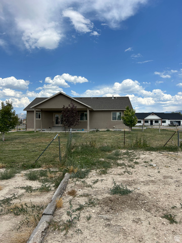 175 North 100th West Centerfield, UT 84622 - Photo 4 of 32 Single-story stucco exterior with a dark shingle roof. Back Yard.