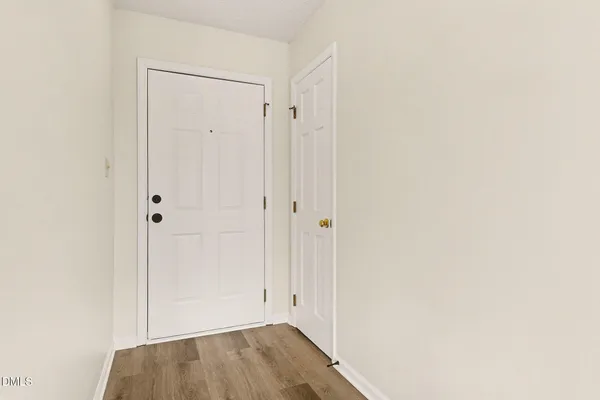 an empty room with a chandelier fan