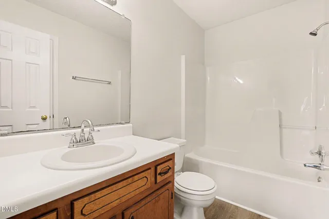 an empty room with a ceiling fan and carpet