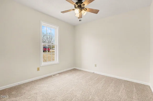 a view of deck with wooden floor and fence next to a yard