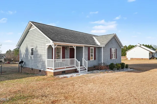 a view of a house with wooden fence