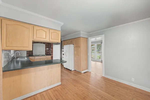 a kitchen with granite countertop a refrigerator and a sink