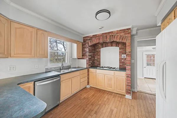 a kitchen with stainless steel appliances granite countertop a stove a sink and a refrigerator