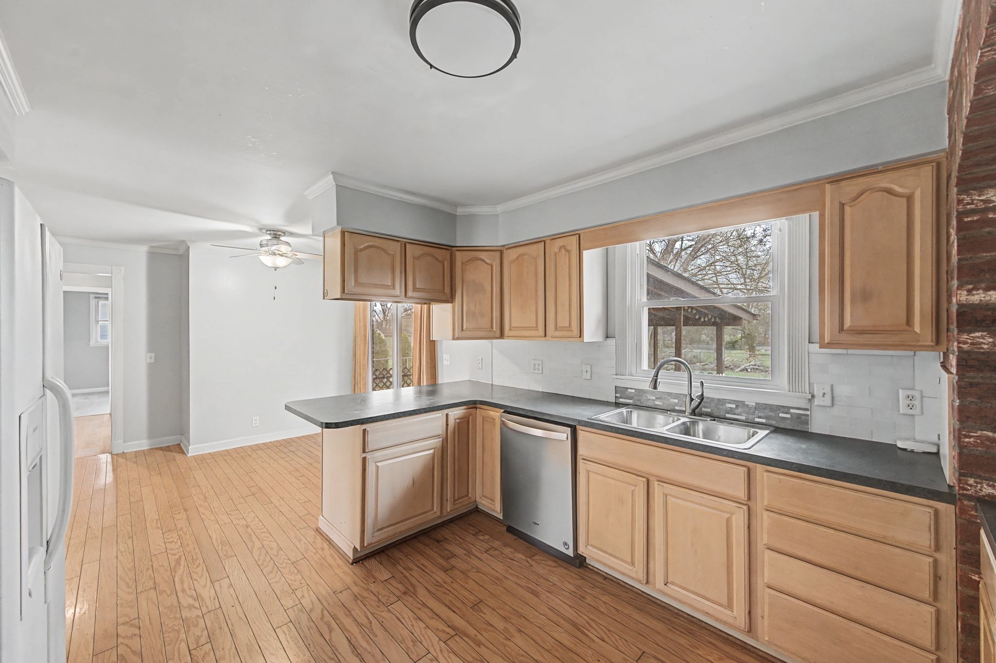 551 Bellevue Road North Nashville, TN 37221 - Photo 16 of 45 a kitchen with stainless steel appliances granite countertop a sink cabinets and wooden floor