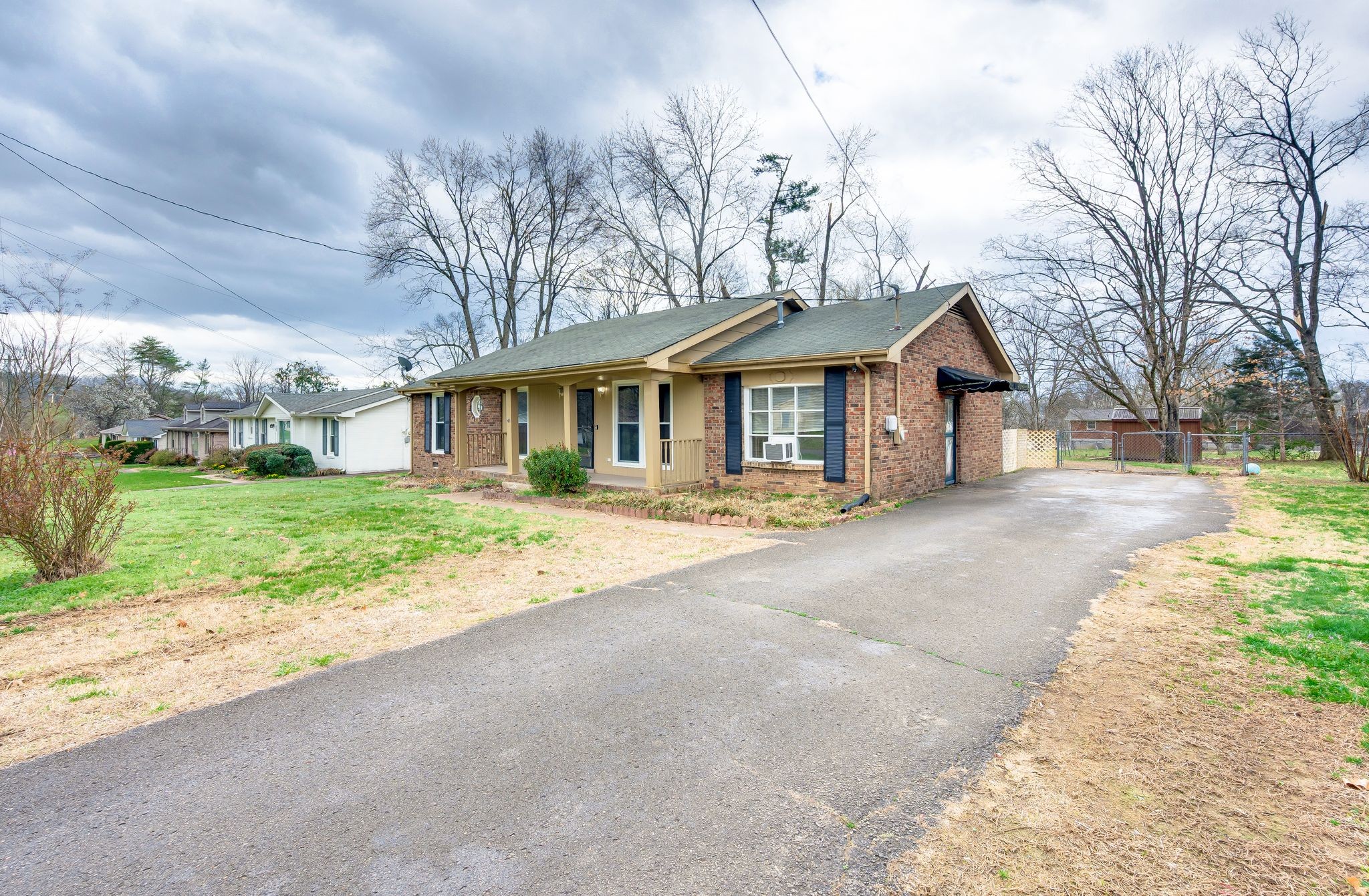 551 Bellevue Road North Nashville, TN 37221 - Photo 2 of 45 a front view of a house with a yard and garage