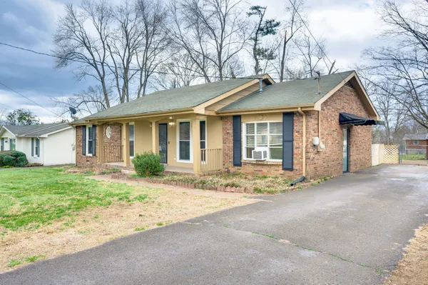 a front view of a house with a garden and yard