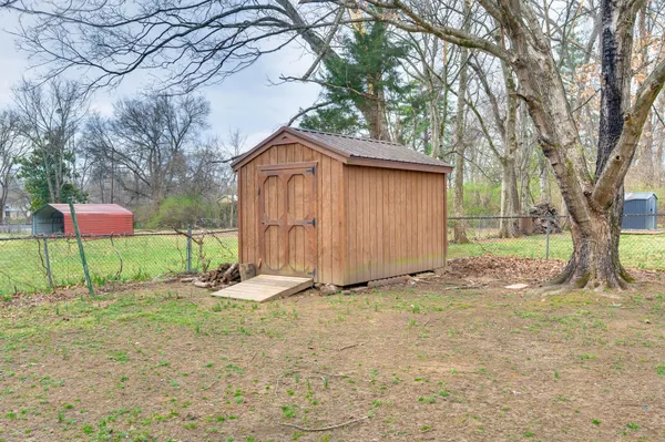 a backyard of a house with table and chairs