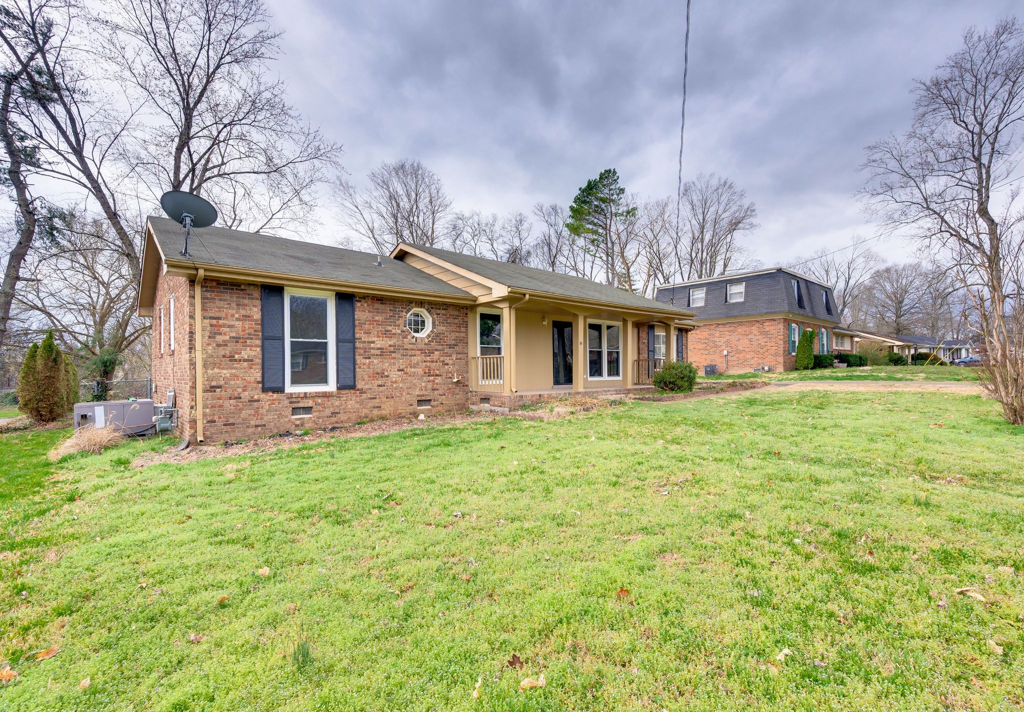 551 Bellevue Road North Nashville, TN 37221 - Photo 4 of 45 a front view of a house with a garden and trees