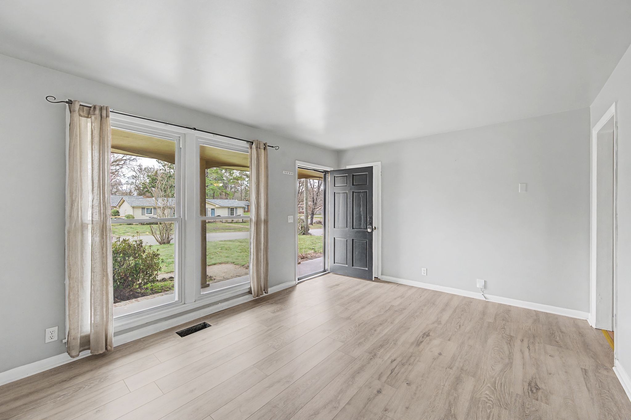 551 Bellevue Road North Nashville, TN 37221 - Photo 6 of 45 a view of an empty room with wooden floor and a window