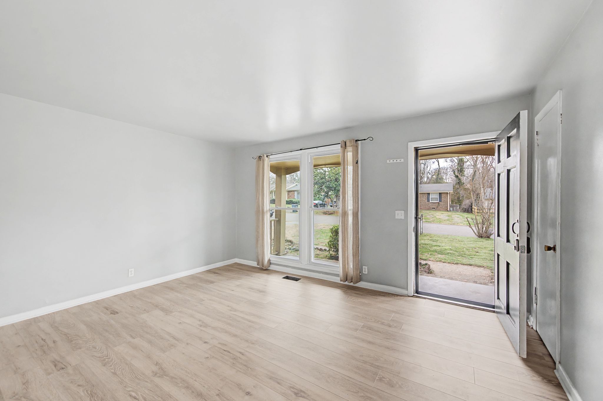 551 Bellevue Road North Nashville, TN 37221 - Photo 9 of 45 an empty room with wooden floor and windows