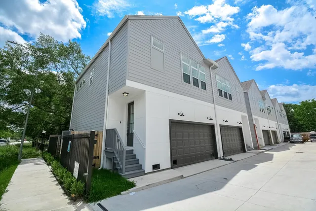 a front view of a house with plants
