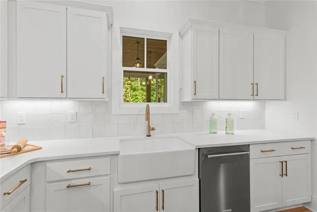 a kitchen with white cabinets and white appliances