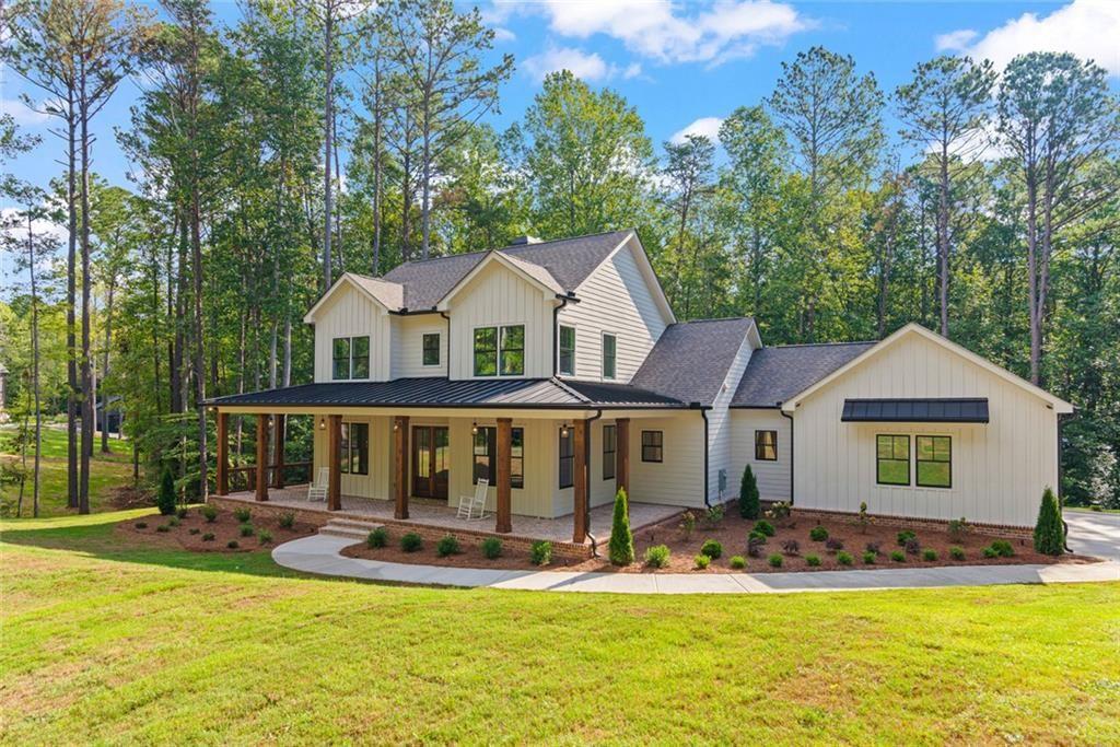 240 Highlands Ball Ground, GA 30107 - Photo 2 of 57 a view of a large pool with lawn chairs under an umbrella