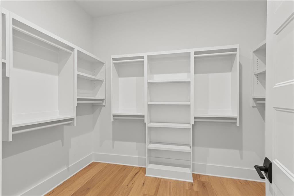 240 Highlands Ball Ground, GA 30107 - Photo 30 of 57 a view of walk in closet with empty racks