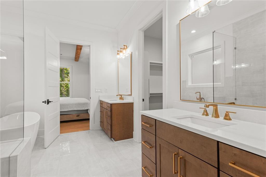 240 Highlands Ball Ground, GA 30107 - Photo 31 of 57 a bathroom with a tub sink and mirror