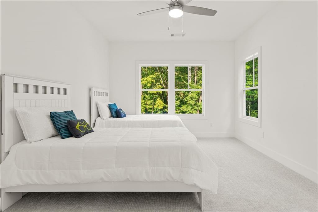 240 Highlands Ball Ground, GA 30107 - Photo 35 of 57 a bed sitting in a bedroom next to a window