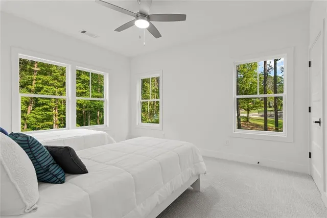 a bedroom with a bed and a chair