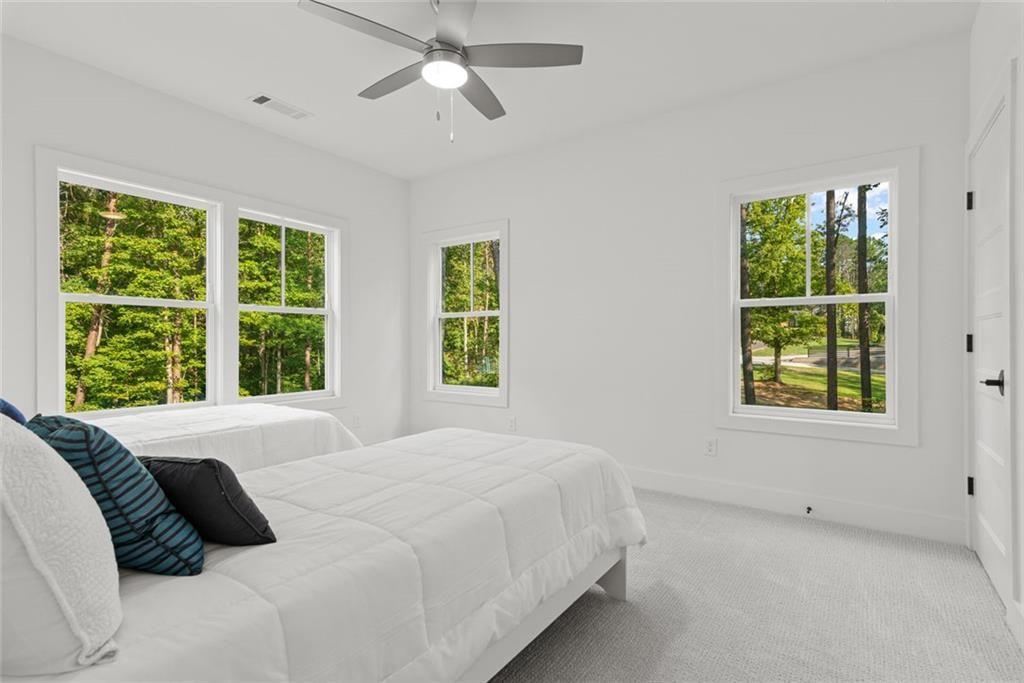 240 Highlands Ball Ground, GA 30107 - Photo 36 of 57 a bedroom with a large bed and a window