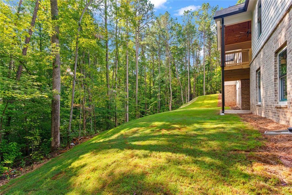 240 Highlands Ball Ground, GA 30107 - Photo 50 of 57 a backyard of a house with lots of green space and fountain
