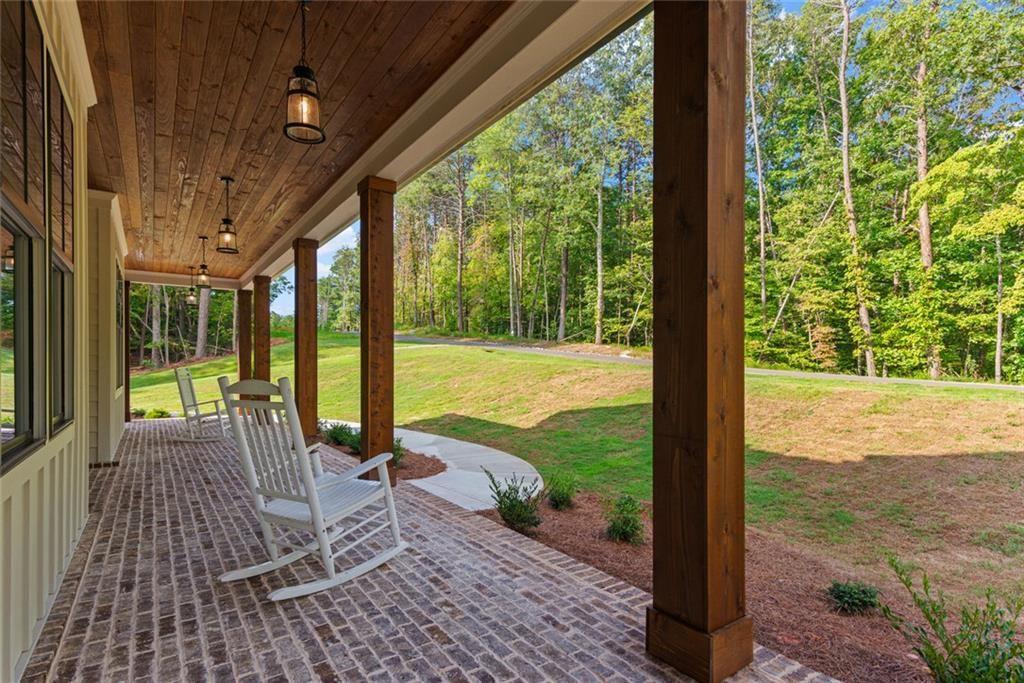240 Highlands Ball Ground, GA 30107 - Photo 7 of 57 a view of a patio with a table chairs and garden
