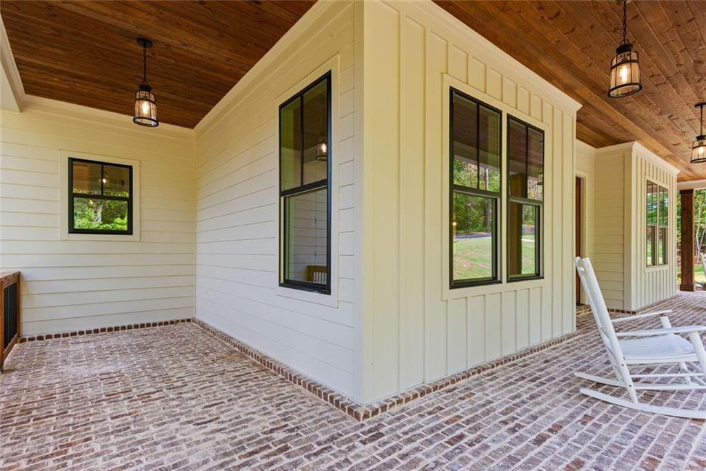 240 Highlands Ball Ground, GA 30107 - Photo 8 of 57 a view of a porch with a table and chairs