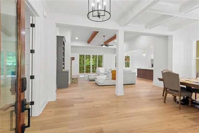 a view of empty room with window and wooden floor