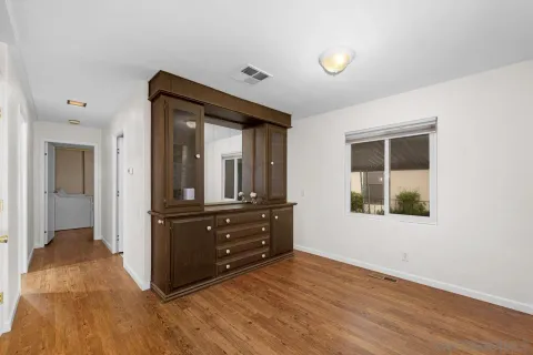 a room with a dresser and a window