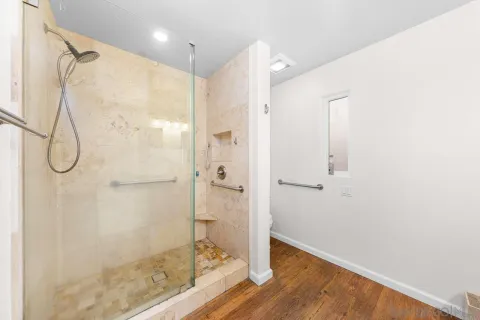 a bathroom with a glass shower door