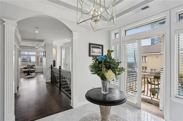 a living room with furniture and a chandelier