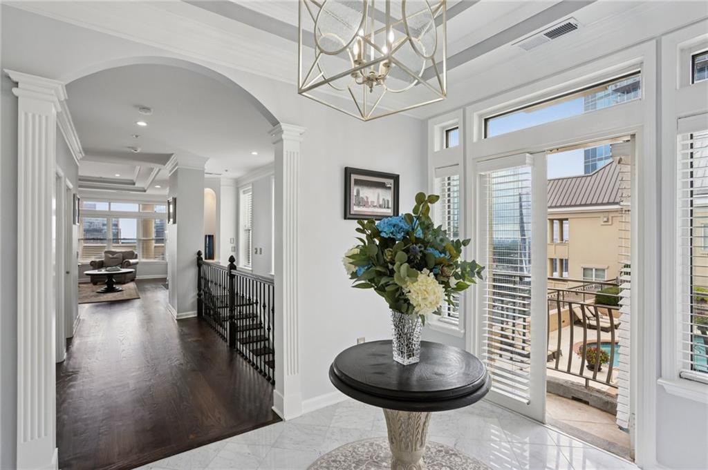 a living room with furniture and a chandelier