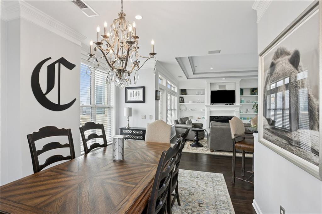 3334 Peachtree Road Northeast, Unit 1908 Atlanta, GA 30326 - Photo 15 of 46 a view of a dining room with furniture chandelier and wooden floor