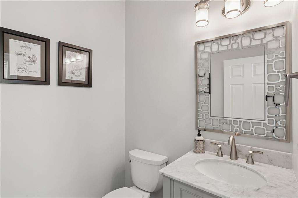 3334 Peachtree Road Northeast, Unit 1908 Atlanta, GA 30326 - Photo 20 of 46 a bathroom with a toilet a sink and mirror