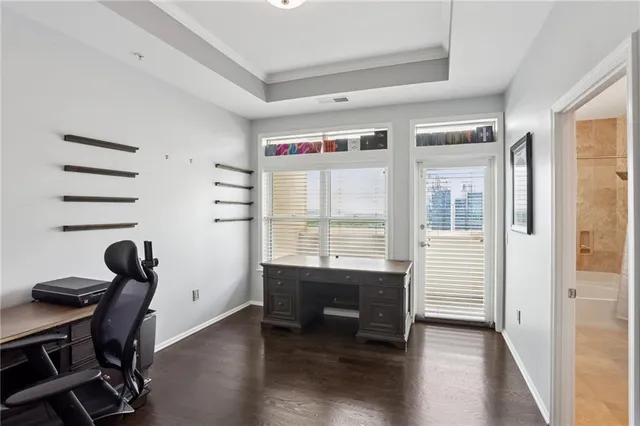 a view of a workspace with furniture and a window