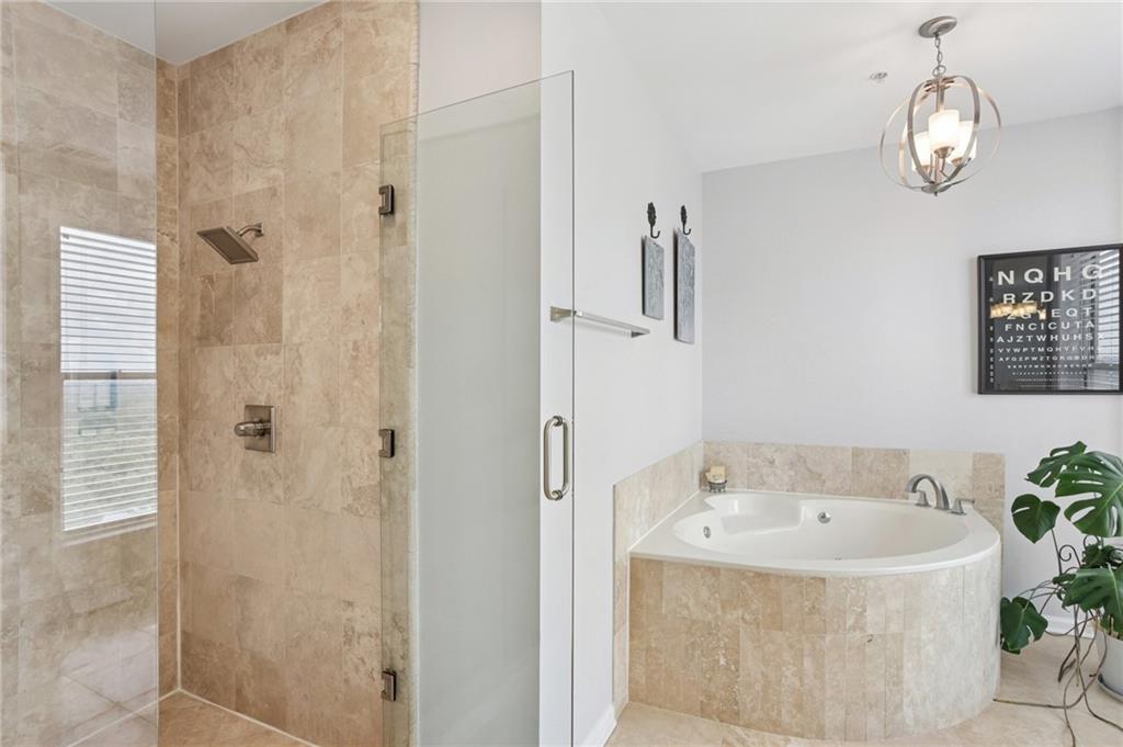 3334 Peachtree Road Northeast, Unit 1908 Atlanta, GA 30326 - Photo 31 of 46 a bathroom with a bathtub and shower