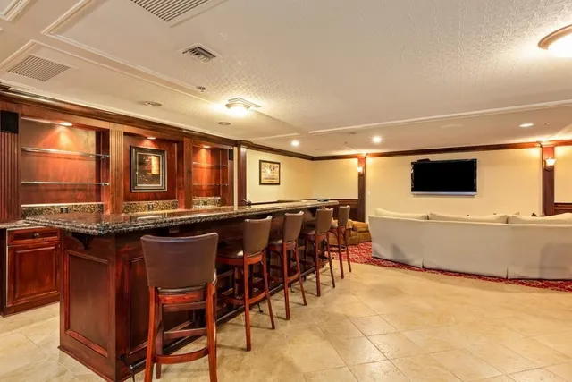 a room with pool table and windows
