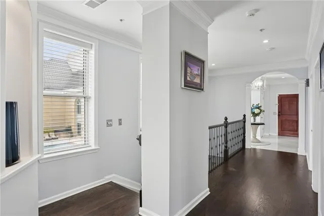 a view of a hallway with wooden floor and a living room