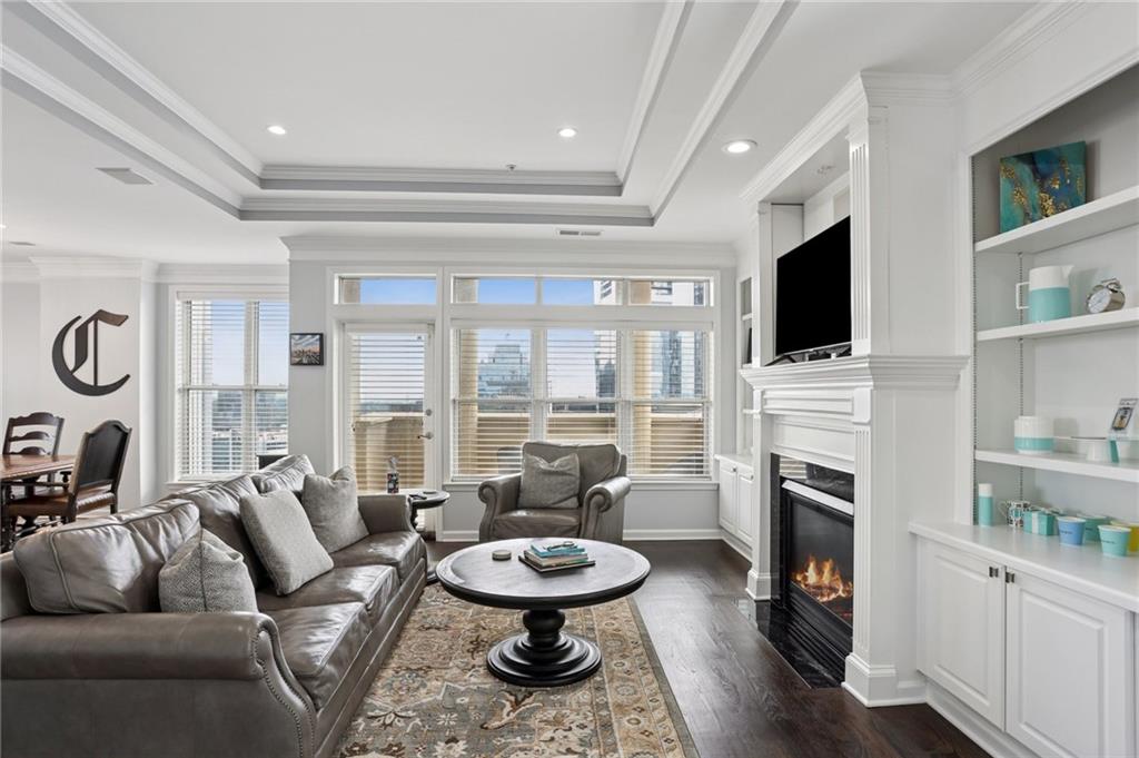 3334 Peachtree Road Northeast, Unit 1908 Atlanta, GA 30326 - Photo 6 of 46 a living room with furniture a fireplace and a flat screen tv