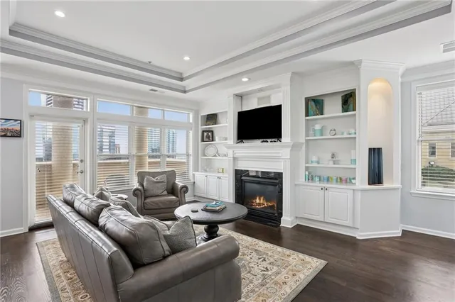 a living room with furniture a fireplace and a flat screen tv