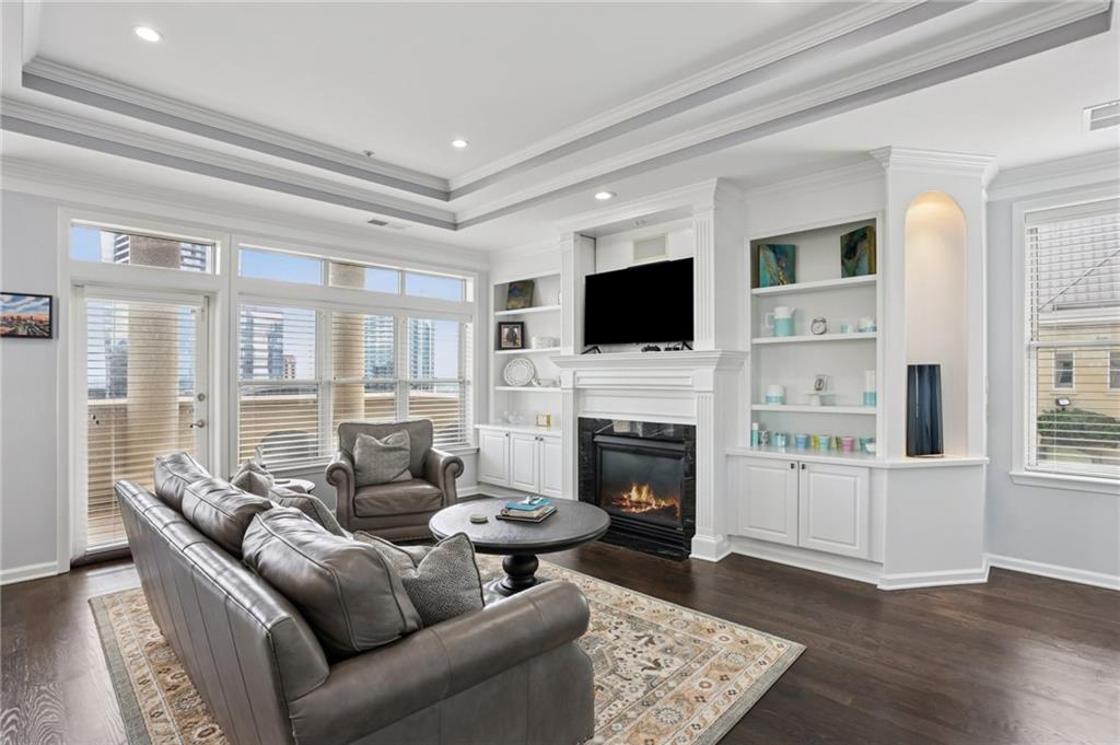 3334 Peachtree Road Northeast, Unit 1908 Atlanta, GA 30326 - Photo 8 of 46 a living room with furniture a fireplace and a flat screen tv