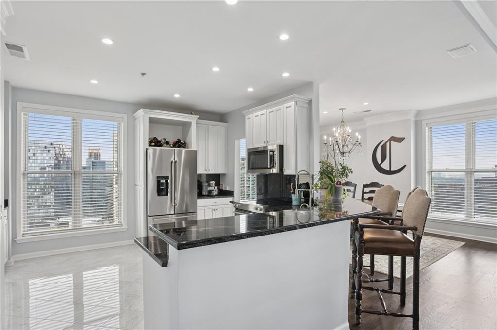 3334 Peachtree Road Northeast, Unit 1908 Atlanta, GA 30326 - Photo 9 of 46 a living room with furniture a large window and a clock