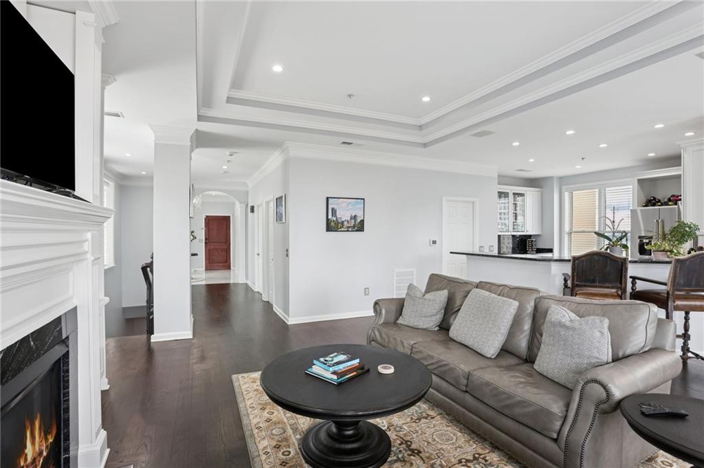 3334 Peachtree Road Northeast, Unit 1908 Atlanta, GA 30326 - Photo 10 of 46 a living room with furniture a fireplace and a flat screen tv